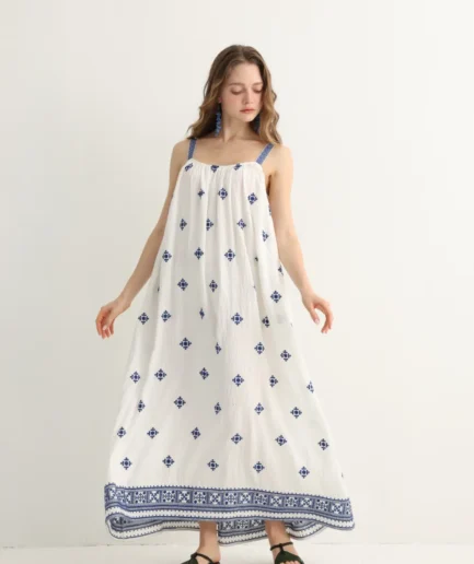 navy floral embroidery on Greek-inspired white maxi dress